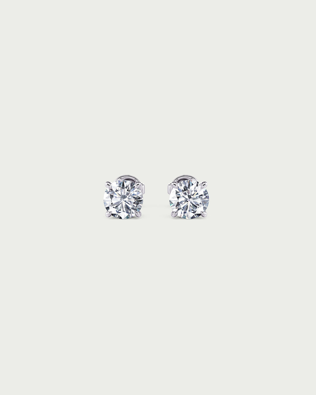 solo product shot of 18k white gold lab grown diamond stud earrings on off-white background