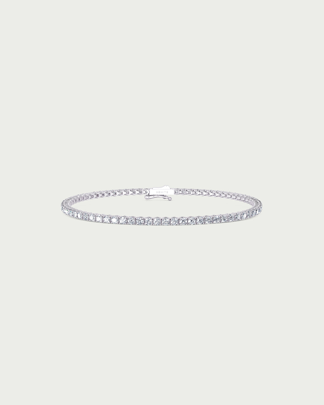 solo product shot of 18k white gold lab grown diamond tennis bracelet on off-white background