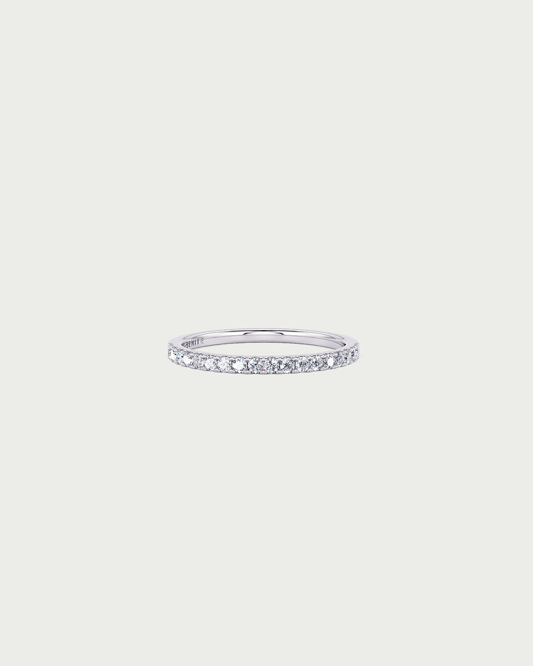 solo product shot of 18k white gold lab grown diamond half eternity band ring on off-white background