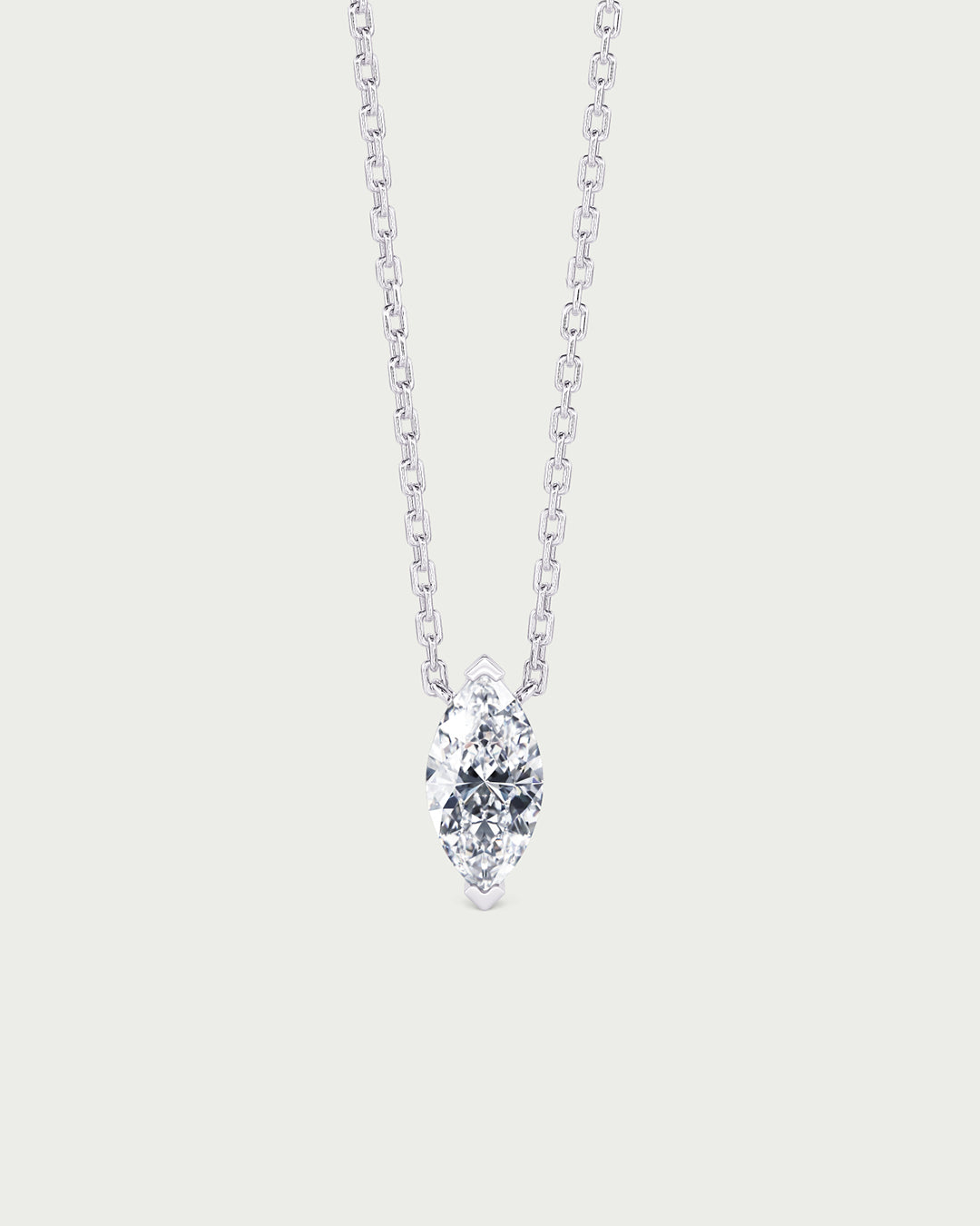 solo product shot of 18k white gold lab grown diamond marquise pendant necklace on off-white background